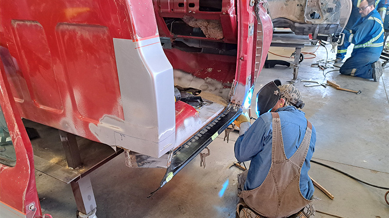Trevor Whelan practicing welding on a vehicle body