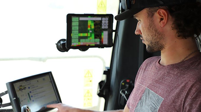 A student operates technology inside a tractor