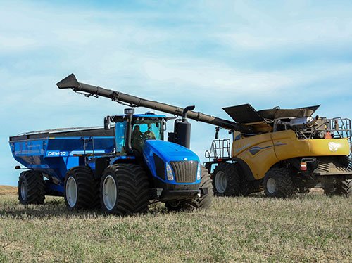 Two New Holland tractors being operated during harvest 2024