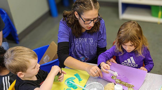 Maddie Buhler works with children for her art implementation project.