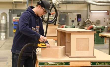 Student building a cabinet