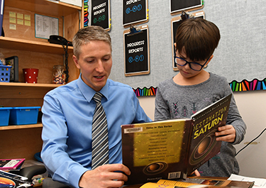 Craig Blythe and a student learn about Saturn and outer space.