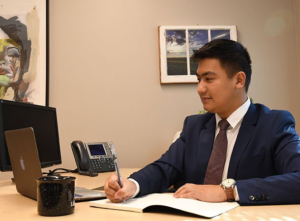 Student taking notes at a business office