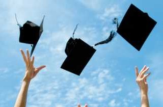 Grad hats flying in the air