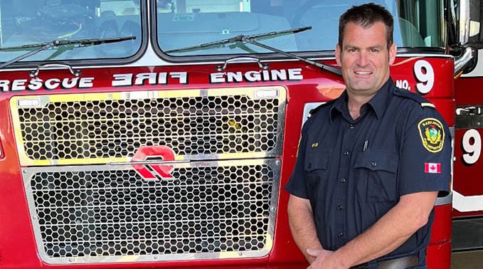 Scott before a firetruck