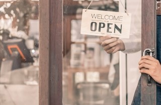 Business putting up an open sign