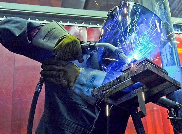 Sparks fly as a welder works in the shop